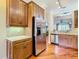 Kitchen with stainless steel appliances, wood cabinetry and hardwood flooring at 16112 Amethyst Key Dr, Wimauma, FL 33598