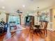Spacious living area with hardwood floors, a dining table, and a comfortable seating area at 16112 Amethyst Key Dr, Wimauma, FL 33598