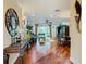 Open-concept living area featuring hardwood floors and large windows at 16112 Amethyst Key Dr, Wimauma, FL 33598