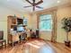 Bright office space with hardwood floors, large windows, stylish ceiling fan, and charming decor at 16112 Amethyst Key Dr, Wimauma, FL 33598