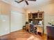 This office features wood floors, a ceiling fan and built-in shelving unit with storage at 16112 Amethyst Key Dr, Wimauma, FL 33598