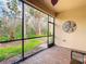Screened-in patio boasting brick flooring and scenic views of the verdant landscaping and backyard at 16112 Amethyst Key Dr, Wimauma, FL 33598