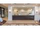 Elegant reception area featuring a modern desk with the Valencia Lakes logo and stylish decor at 16112 Amethyst Key Dr, Wimauma, FL 33598