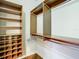 Walk-in closet features wood shelving and metal rods for hanging clothes; ample space for organization at 16112 Amethyst Key Dr, Wimauma, FL 33598