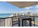 Balcony with table and chairs overlooking the beach and ocean, providing a relaxing outdoor space at 1660 Gulf Blvd # Ph2, Clearwater Beach, FL 33767