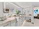 Bright bathroom featuring double vanity sinks, granite countertops, and a view to the bedroom at 1660 Gulf Blvd # Ph2, Clearwater Beach, FL 33767