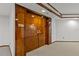 Hallway entrance with wood paneled doors, carpet flooring, and white walls leading inside at 1660 Gulf Blvd # Ph2, Clearwater Beach, FL 33767