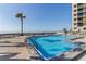 Stunning outdoor pool area featuring ample seating and beautiful ocean views at 1660 Gulf Blvd # Ph2, Clearwater Beach, FL 33767