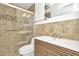 Modern bathroom with a glass shower, tiled walls, and a wood vanity sink at 1740 Coco Palm Cir, Sun City Center, FL 33573