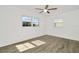 Inviting bedroom with wood-look flooring and ample natural light from multiple windows at 1740 Coco Palm Cir, Sun City Center, FL 33573