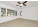 Sunlit bedroom with large windows, tile flooring, and a ceiling fan for added comfort at 1740 Coco Palm Cir, Sun City Center, FL 33573