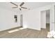 This bedroom features a ceiling fan, wood-look floors, and natural light from the window at 1740 Coco Palm Cir, Sun City Center, FL 33573