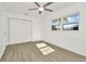 Bedroom featuring wood-look flooring, a ceiling fan, and a double-door closet at 1740 Coco Palm Cir, Sun City Center, FL 33573