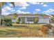 Charming single-story home with a well-maintained lawn and mature landscaping at 1740 Coco Palm Cir, Sun City Center, FL 33573
