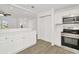 Contemporary kitchen with stainless steel range and oven, stone countertops, and bright white cabinetry at 1740 Coco Palm Cir, Sun City Center, FL 33573