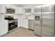 Well-equipped kitchen boasts modern appliances, ample counter space and white cabinets at 1740 Coco Palm Cir, Sun City Center, FL 33573