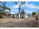 View of the backyard with a detached unit that has gray siding and a white front door at 1931 24Th S St, St Petersburg, FL 33712