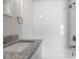 Bright bathroom with a shower-tub combo and a granite vanity at 1931 24Th S St, St Petersburg, FL 33712