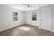 Cozy bedroom featuring wood-look floors, a ceiling fan, and natural light from the windows at 1931 24Th S St, St Petersburg, FL 33712