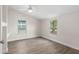 Bright bedroom featuring wood-look floors, neutral walls, and a ceiling fan at 1931 24Th S St, St Petersburg, FL 33712