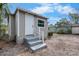 Backyard view of detached unit with white door, concrete steps and neutral gray color scheme at 1931 24Th S St, St Petersburg, FL 33712