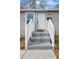 Home entrance with freshly painted door, a white picket railing and modern address numbers at 1931 24Th S St, St Petersburg, FL 33712