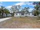 Gray home with tidy front yard, complemented by a freshly poured driveway at 1931 24Th S St, St Petersburg, FL 33712