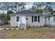 Charming home featuring gray siding, dark roof, and neatly landscaped front yard at 1931 24Th S St, St Petersburg, FL 33712