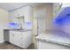 Bright kitchen with white cabinetry, stainless steel sink, and granite countertops at 1931 24Th S St, St Petersburg, FL 33712