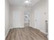 Open living room showcasing modern wood floors and neutral paint, leading to a bright kitchen at 1931 24Th S St, St Petersburg, FL 33712