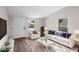 Staged living room with modern white furniture and natural lighting at 1931 24Th S St, St Petersburg, FL 33712