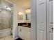 Bathroom features granite counters, white cabinetry, tiled shower with tub and door to linen closet at 200 Country Club Dr # 503, Largo, FL 33771