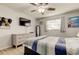 A cozy bedroom with light-colored walls, a ceiling fan, and a modern dresser and decor at 200 Country Club Dr # 503, Largo, FL 33771