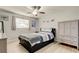 A serene bedroom featuring a ceiling fan, natural light, and a sleek dresser and wardrobe at 200 Country Club Dr # 503, Largo, FL 33771