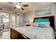 A comfortable bedroom with a ceiling fan, beach-themed decor, and a crib creates a cozy retreat at 200 Country Club Dr # 503, Largo, FL 33771