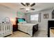 A relaxing bedroom with a ceiling fan, natural light, and a crib, creating a warm atmosphere at 200 Country Club Dr # 503, Largo, FL 33771