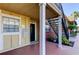 Condo exterior featuring a covered porch and staircase to the upper level at 200 Country Club Dr # 503, Largo, FL 33771