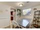 Cozy dining room with white wainscoting, light gray floor, and adjacent kitchen at 200 Country Club Dr # 503, Largo, FL 33771