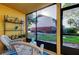 Screened porch features outdoor furniture and pleasant views of the landscaping at 200 Country Club Dr # 503, Largo, FL 33771