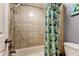 Shower with tub features tiled walls, shower head, faucet and decorative tiled border at 200 Country Club Dr # 503, Largo, FL 33771