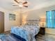 Cozy bedroom boasts a comfortable bed with matching nightstands and a ceiling fan at 2606 Oak Cir, Tarpon Springs, FL 34689