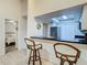 Bright kitchen featuring granite counters, seating at the breakfast bar, and stainless steel appliances at 2606 Oak Cir, Tarpon Springs, FL 34689