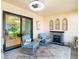 Outdoor patio space featuring cozy seating, a faux fireplace, and a sliding glass door at 2606 Oak Cir, Tarpon Springs, FL 34689