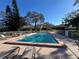 Relaxing community pool area with lounge chairs and tables for residents' enjoyment on a sunny day at 2606 Oak Cir, Tarpon Springs, FL 34689