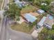 Aerial view of a fenced property with gravel and grassy areas around a metal roof home at 3166 13Th N Ave, St Petersburg, FL 33713