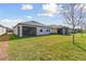 Well-maintained backyard features a lush lawn, screened-in patio, and views of neighboring properties, offering a private retreat at 31675 Cannon Rush Dr, San Antonio, FL 33576