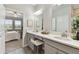 Bathroom vanity with dual sinks, framed mirrors, with bedroom view at 31675 Cannon Rush Dr, San Antonio, FL 33576