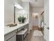 Bathroom featuring dual sink vanity, framed mirrors, and a step-in glass shower at 31675 Cannon Rush Dr, San Antonio, FL 33576
