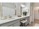 Bathroom with a dual sink vanity, framed mirrors, and modern fixtures at 31675 Cannon Rush Dr, San Antonio, FL 33576
