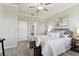Bright bedroom with plush carpet, ceiling fan, and stylish gray furnishings at 31675 Cannon Rush Dr, San Antonio, FL 33576